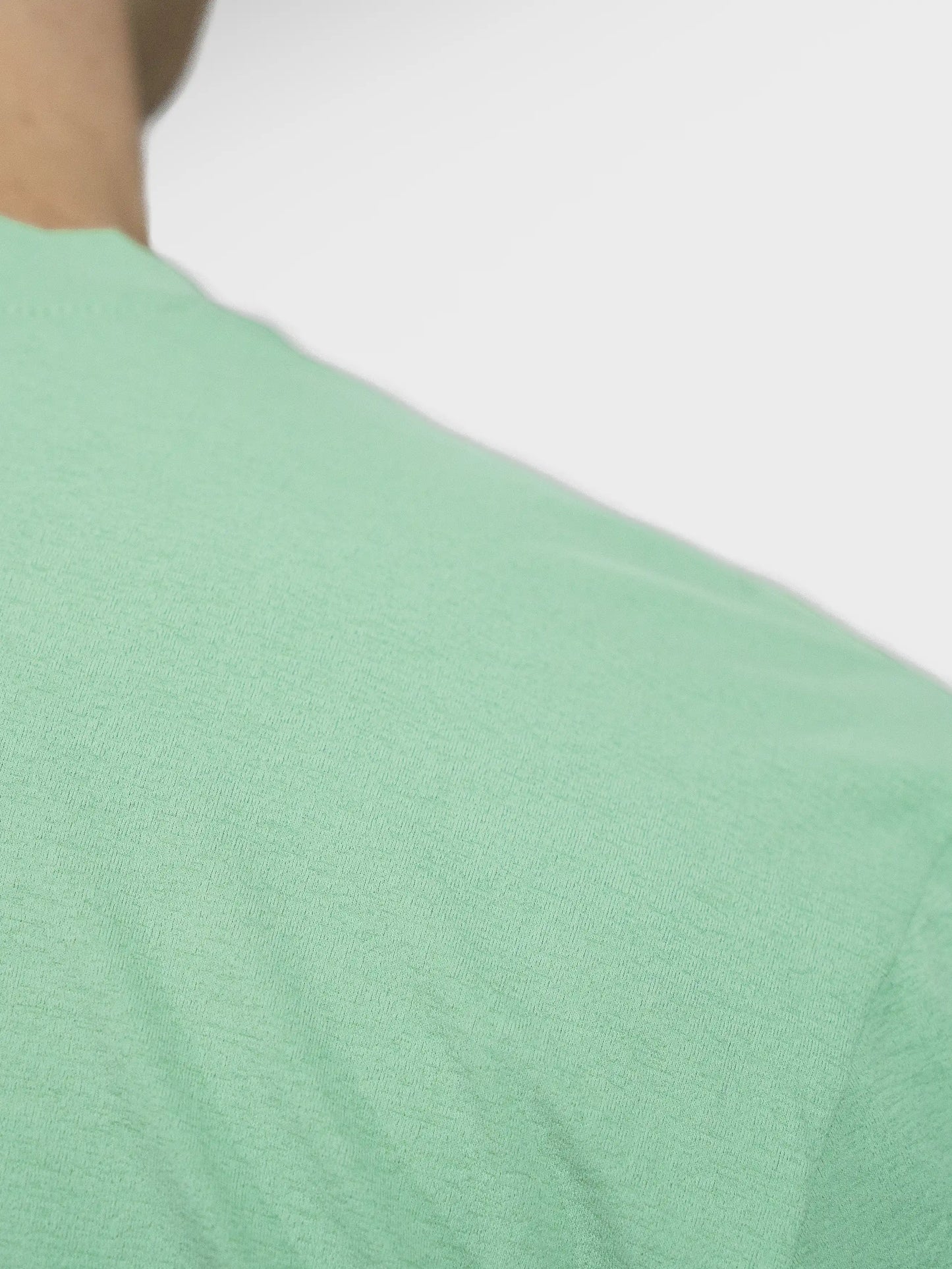 Close up of Clay Active's men's workout and training gym tee shirt showing the sustainable fabric. Sage colour.