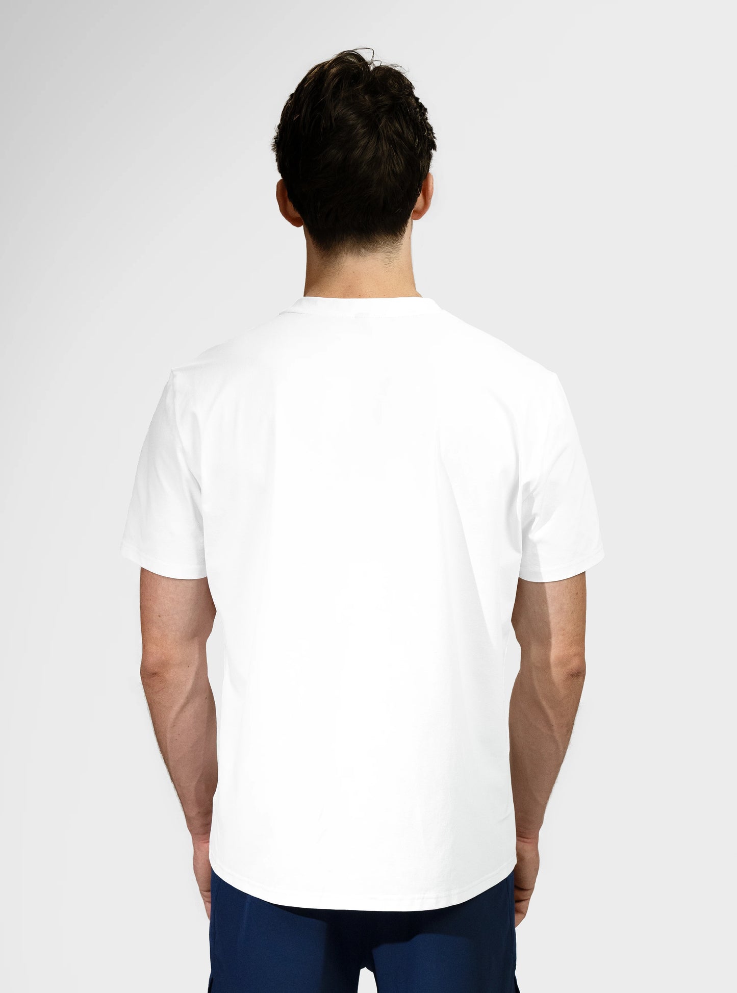 Gym tee shirt. Clay Active's workout and training shirt back view. White colour.