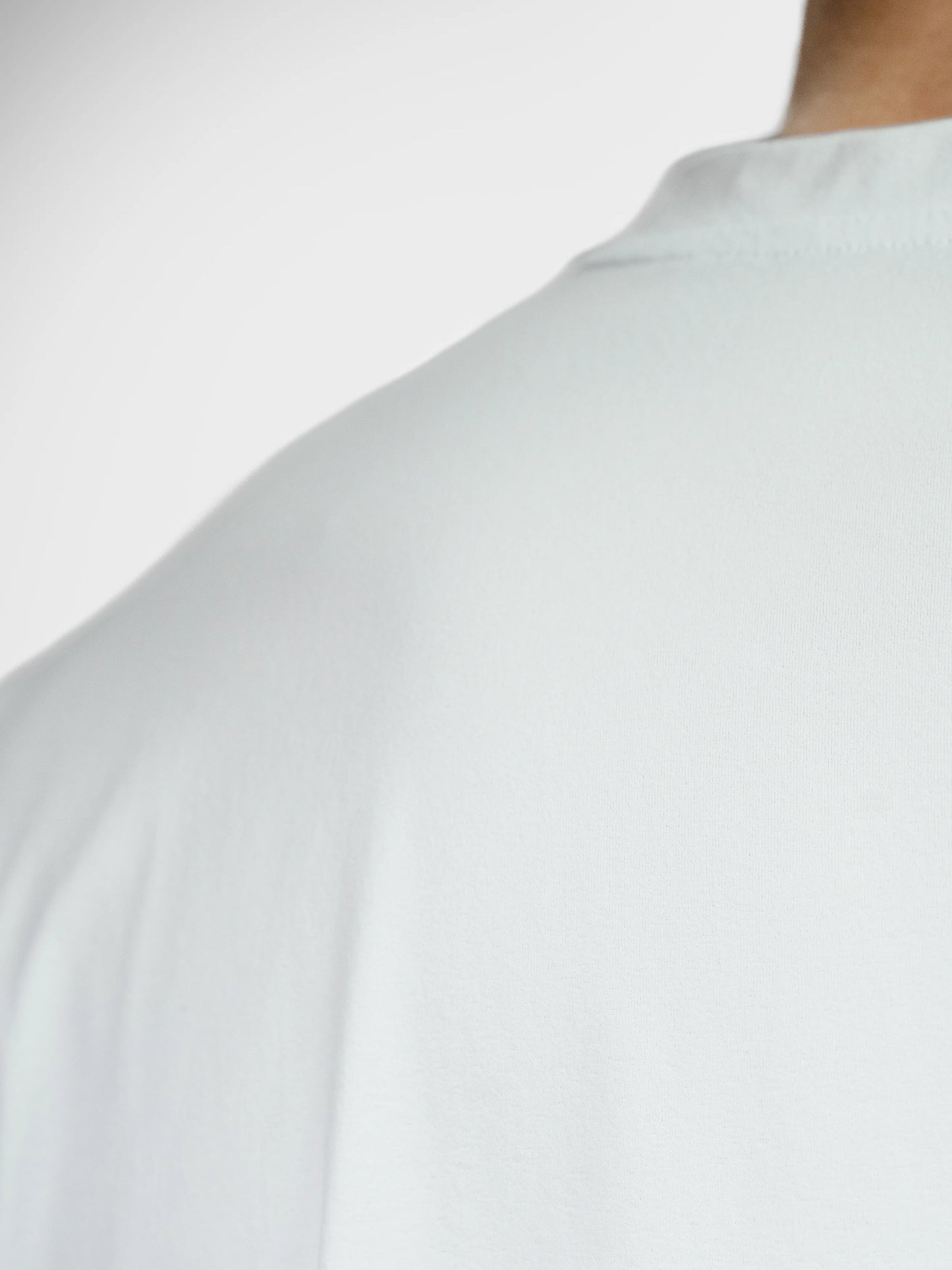 Close up of Clay Active men's workout and training tee shirt sustainable fabric. White colour.