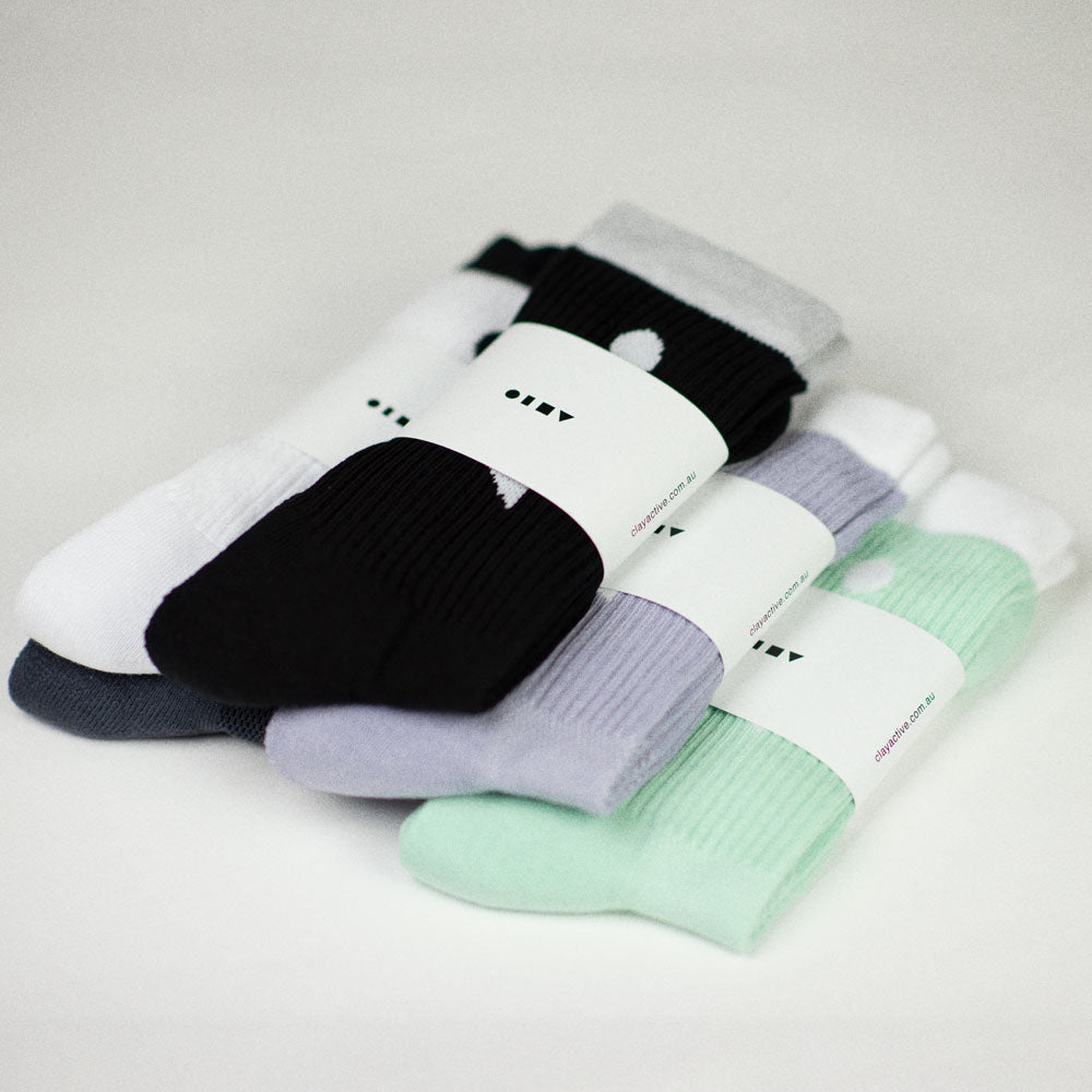 Clay Active's men's athletic crew socks 5 pairs in packaging, studio.