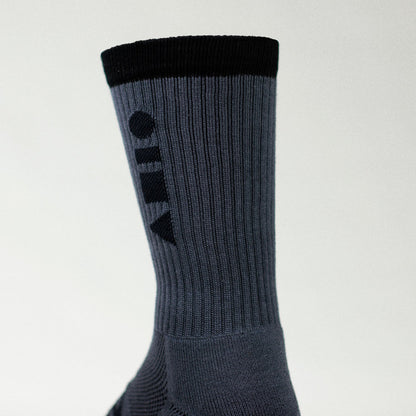 Clay Active grey men's athletic crew sock showing cushioning in studio.