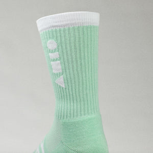 Clay Active green men's athletic sock showing cushioning in studio.