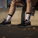 Clay Active men's white athletic crew socks with New Balance shoes in Melbourne basketball court.